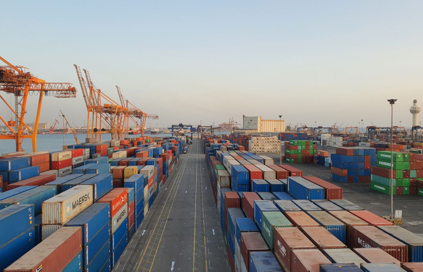 Container cranes and stacked containers at a marine terminal